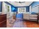 Stylish bedroom featuring blue walls, hardwood floors, and plenty of natural light at 188 Ponderosa Cir, Mooresville, NC 28117