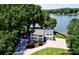 Charming two-story waterfront home featuring lush mature trees and a well-manicured front lawn at 188 Ponderosa Cir, Mooresville, NC 28117