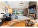 Comfortable living room featuring hardwood floors, vaulted ceiling, and views through sliding glass doors to lake and deck at 188 Ponderosa Cir, Mooresville, NC 28117