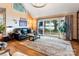 Cozy living room boasting hardwood floors, a vaulted ceiling, and sliding glass doors that reveal a beautiful lake view at 188 Ponderosa Cir, Mooresville, NC 28117