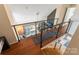 Open loft area overlooking the lower level with modern railings and natural light at 188 Ponderosa Cir, Mooresville, NC 28117
