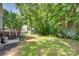 Large, green backyard with mature trees, a deck, and storage shed at 2014 Steeplechase Dr, Rock Hill, SC 29732