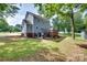 Well-maintained yard showcasing a two-story home with a spacious back deck and lush landscaping at 2014 Steeplechase Dr, Rock Hill, SC 29732