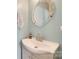 Charming bathroom features a stylish vanity sink with modern faucet, decorative mirror and soft blue walls at 2014 Steeplechase Dr, Rock Hill, SC 29732