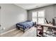 Bright bedroom featuring a large window with shutters, gray walls, and stylish desk space for optimal work-from-home at 2014 Steeplechase Dr, Rock Hill, SC 29732
