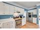 Bright kitchen boasts stainless steel appliances, ample white cabinetry, and hardwood floors for a modern touch at 2014 Steeplechase Dr, Rock Hill, SC 29732