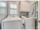 Functional laundry room equipped with washer, dryer, cabinet storage, and a window for natural light at 2014 Steeplechase Dr, Rock Hill, SC 29732