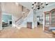 Bright open-concept living area with stairs, access to other rooms, and hardwood flooring at 2014 Steeplechase Dr, Rock Hill, SC 29732