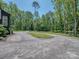 Circular driveway surrounded by mature trees offering ample parking at 202 Walden Ln, Weddington, NC 28104
