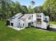 Beautiful two-story home showcasing modern design and landscaped yard with mature trees at 202 Walden Ln, Weddington, NC 28104