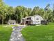 Beautiful two-story home with an attached garage and lush green lawn at 202 Walden Ln, Weddington, NC 28104