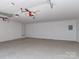 Clean and spacious garage interior with epoxy flooring, perfect for parking and storage at 202 Walden Ln, Weddington, NC 28104
