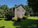 Charming two-story home with lush green lawn and mature trees surrounding the property at 204 Brentwood Dr, Maiden, NC 28650