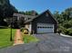 Charming home featuring an attached two-car garage, manicured lawn, and inviting brick walkway at 204 Brentwood Dr, Maiden, NC 28650