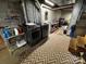 Laundry room setup featuring modern washer and dryer units, shelving, and a patterned rug at 204 Brentwood Dr, Maiden, NC 28650