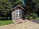 Features of a backyard shed with double doors, set amidst greenery at 204 Brentwood Dr, Maiden, NC 28650
