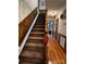 Carpeted staircase with wood trim and bannister leads to the upper level at 204 Brentwood Dr, Maiden, NC 28650