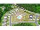 Aerial view of community featuring a pool, playground, parking, green spaces, and well-maintained homes at 2296 Idol Rock Dr, Indian Land, SC 29707