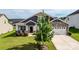Charming home with a stone-accented facade, two-car garage, manicured lawn, and a cozy front porch at 2296 Idol Rock Dr, Indian Land, SC 29707