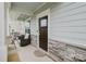 Inviting front porch with stone accents, stylish seating, and a beautifully stained front door at 2296 Idol Rock Dr, Indian Land, SC 29707