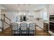 Bright kitchen featuring white cabinets, an island with seating, and modern pendant lighting at 2296 Idol Rock Dr, Indian Land, SC 29707