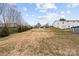 Expansive backyard featuring a large grassy area, mature trees, and an outdoor swimming pool at 24253 Old Aquadale Rd, Albemarle, NC 28001
