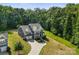 Scenic aerial shot of gray home with manicured lawn, set against a backdrop of lush green trees at 2525 Surveyor General Dr, Waxhaw, NC 28173