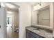 Bathroom with gray vanity, granite countertop, toilet, tile flooring, and an open doorway at 2525 Surveyor General Dr, Waxhaw, NC 28173