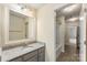 Bathroom features a gray vanity with a granite countertop, a sink, and views into the shower area at 2525 Surveyor General Dr, Waxhaw, NC 28173