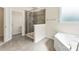 Modern bathroom features tiled walk-in shower and separate tub at 2525 Surveyor General Dr, Waxhaw, NC 28173