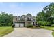 Stunning two-story home with a three car garage, stone accents, manicured landscaping, and a welcoming front porch at 2525 Surveyor General Dr, Waxhaw, NC 28173