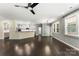 Open living room featuring dark hardwood floors, a modern ceiling fan, and natural light at 2525 Surveyor General Dr, Waxhaw, NC 28173