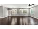 Expansive living room with gleaming hardwood floors, multiple windows, and a view of the outdoor landscape at 2525 Surveyor General Dr, Waxhaw, NC 28173