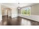 Bright living area with dark hardwood floors, white wainscoting, and a large window at 2525 Surveyor General Dr, Waxhaw, NC 28173