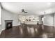 Spacious living room with a fireplace, open floor plan, and dark hardwood flooring throughout at 2525 Surveyor General Dr, Waxhaw, NC 28173