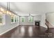 Spacious living area with hardwood floors, a fireplace, and abundant natural light from multiple windows at 2525 Surveyor General Dr, Waxhaw, NC 28173