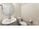 Bright powder room with pedestal sink and toilet at 2525 Surveyor General Dr, Waxhaw, NC 28173