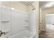 Close up of a shower/tub with white walls and tile flooring, with a door leading to another room at 2525 Surveyor General Dr, Waxhaw, NC 28173