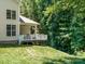 Backyard view featuring deck, lush green lawn, and mature trees at 2545 Chasewater Dr, Fort Mill, SC 29707