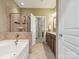 Well-lit bathroom featuring a tub, a tiled shower, and a double vanity, creating a relaxing space at 2545 Chasewater Dr, Fort Mill, SC 29707