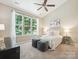 Bright bedroom featuring a vaulted ceiling, a ceiling fan, three large windows, and neutral decor at 2545 Chasewater Dr, Fort Mill, SC 29707