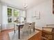 Elegant dining room featuring hardwood floors, natural light from large windows, and a stylish chandelier at 2545 Chasewater Dr, Fort Mill, SC 29707