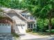 Charming two-story townhome boasts an attached two-car garage, manicured lawn and natural stone accents at 2545 Chasewater Dr, Fort Mill, SC 29707