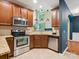 Updated kitchen with stainless steel appliances, granite countertops, and an adjacent archway leading to the next room at 2545 Chasewater Dr, Fort Mill, SC 29707