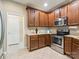 Well-equipped kitchen featuring stainless steel appliances, granite countertops, and rich, dark wood cabinetry at 2545 Chasewater Dr, Fort Mill, SC 29707
