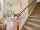 Inviting living room featuring hardwood floors, bright windows, and stairs leading up to the second floor at 2545 Chasewater Dr, Fort Mill, SC 29707