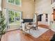 Bright and airy living room with high ceilings, large windows, and an open entryway, showcasing hardwood flooring at 2545 Chasewater Dr, Fort Mill, SC 29707