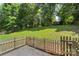 The backyard is fenced in, lush green, and surrounded by mature trees at 3212 Ashwell Oaks Ln, Matthews, NC 28105