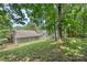 A mature backyard with luscious green grass, privacy, and bordered by mature trees at 3212 Ashwell Oaks Ln, Matthews, NC 28105