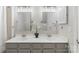 Bathroom featuring double vanity, gray cabinets, modern lighting, and decorative plants at 3212 Ashwell Oaks Ln, Matthews, NC 28105